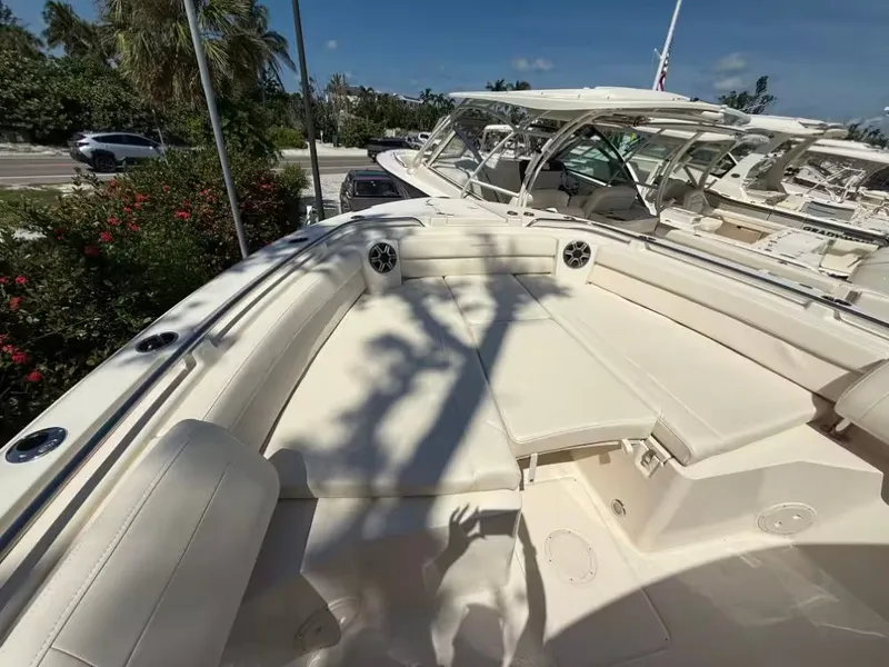 Slide: The Image of 2026 Grady-White Canyon 326 boat with spacious seating, docked under clear skies. - 12