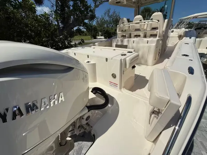 Slide: The Image of 2026 Grady-White Canyon 326 boat interior with Yamaha engine, featuring seating and storage. - 3