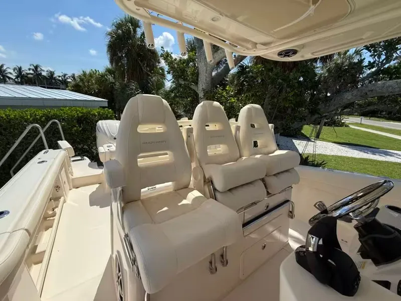 Slide: The Image of 2026 Grady-White Canyon 326 boat interior with luxurious seating and steering wheel. - 4