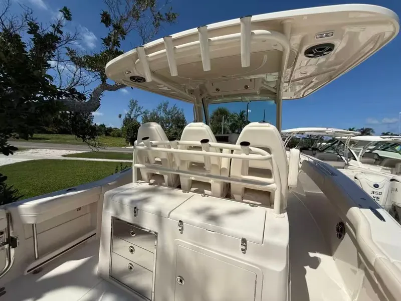 Slide: The Image of 2026 Grady-White Canyon 326 boat interior with seating and storage under a clear blue sky. - 7