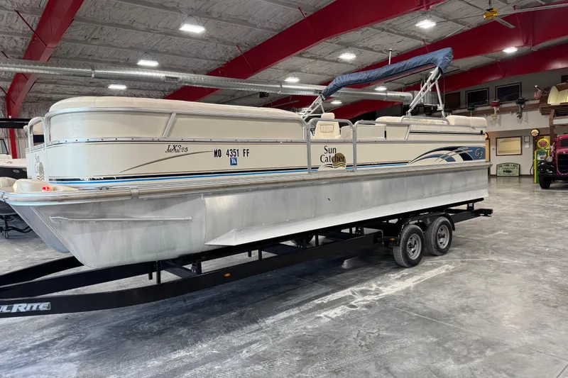 The Image of 2005 G3 Sun Catcher pontoon boat on trailer in indoor showroom. - 1