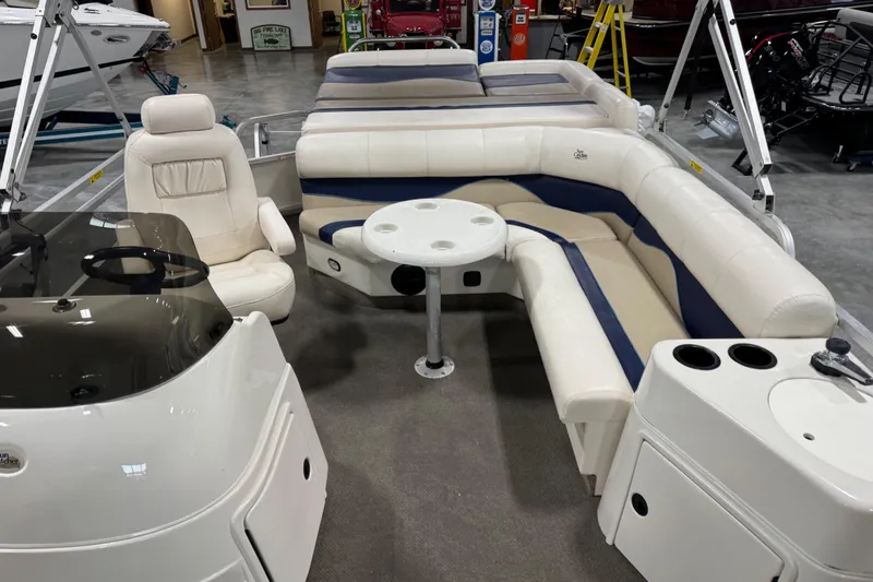 Slide: The Image of Interior of a 2005 G3 boat with white seating and a central table. - 11