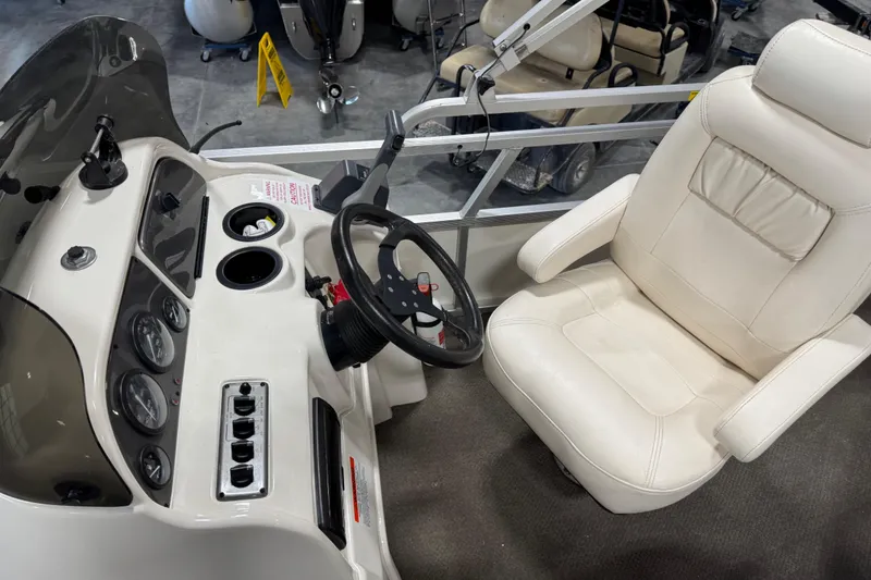 Slide: The Image of Steering console and seat of a 2005 G3 boat, featuring gauges and controls. - 13