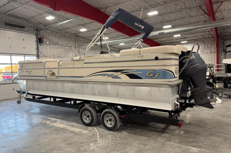Slide: The Image of 2005 G3 SunCatcher pontoon boat on trailer in indoor storage facility. - 3