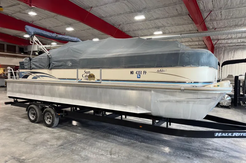 Slide: The Image of 2005 G3 Sun Catcher pontoon boat on trailer in indoor storage. - 5