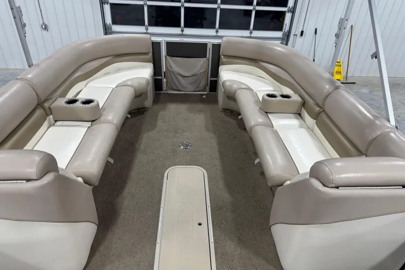 Slide: The Image of 2013 Crest 22 Crest II XRS pontoon boat interior with beige seating and cup holders. - 11