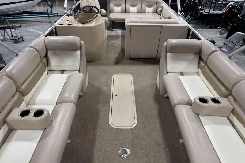 Slide: The Image of 2013 Crest 22 Crest II XRS pontoon boat interior with beige seating and cup holders. - 12