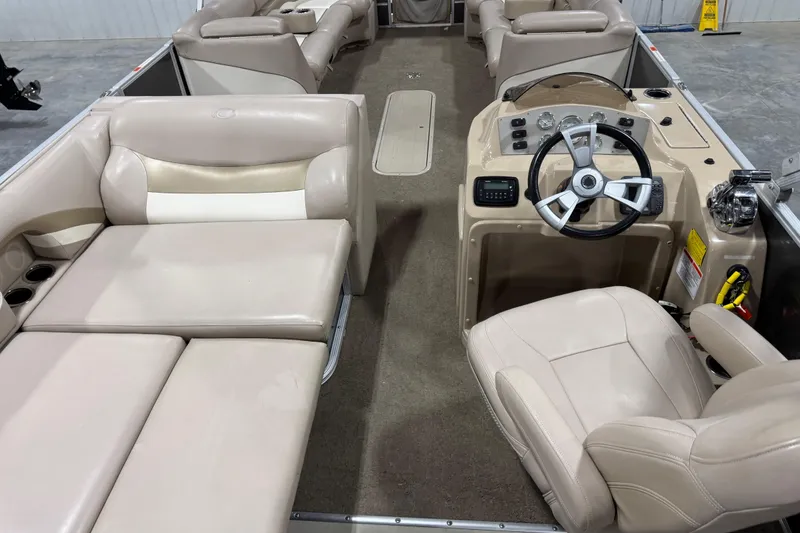 Slide: The Image of Interior of 2013 Crest 22 Crest II XRS pontoon boat with beige seating and steering console. - 8