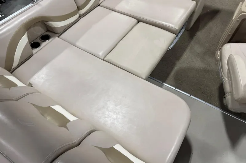 Slide: The Image of 2013 Crest 22 Crest II XRS boat interior with beige seating and cup holders. - 9