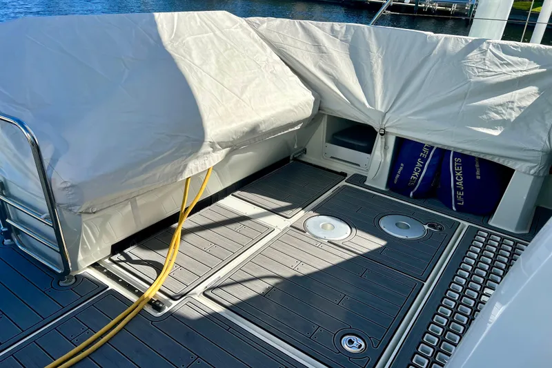 Slide: The Image of 2024 Beneteau Antares 11 deck with covered seating and life jackets. - 19