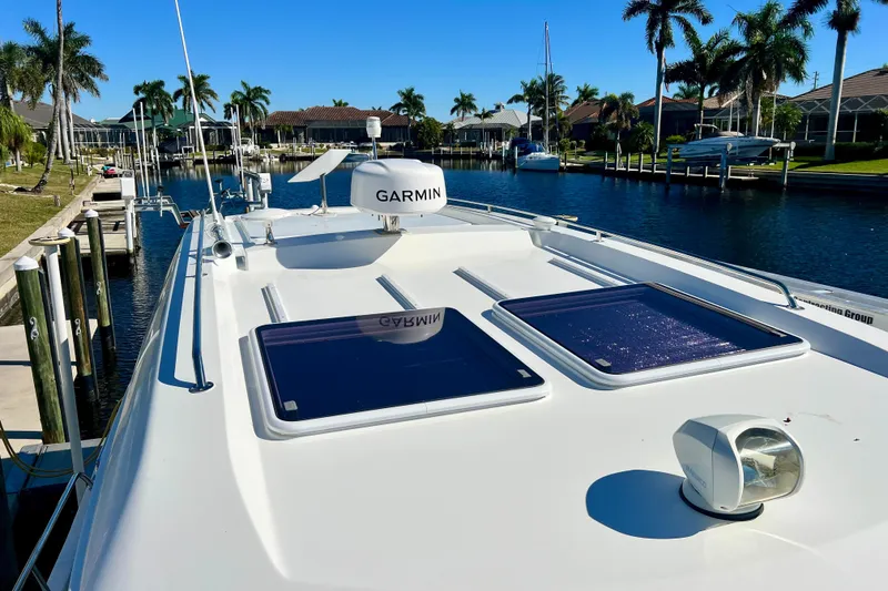 Slide: The Image of 2024 Beneteau Antares 11 yacht with Garmin equipment, docked in a sunny marina. - 24