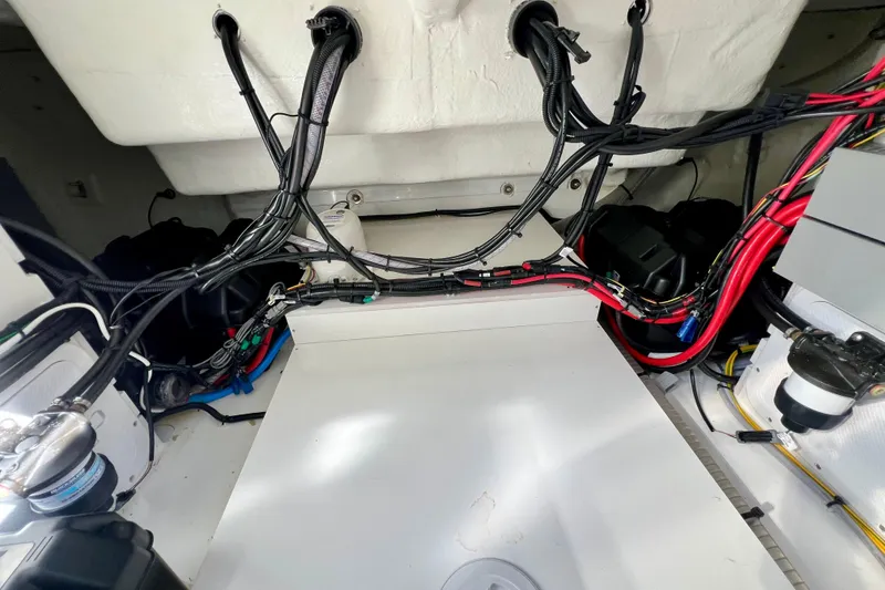 Slide: The Image of 2024 Beneteau Antares 11 engine compartment with wiring and components. - 28