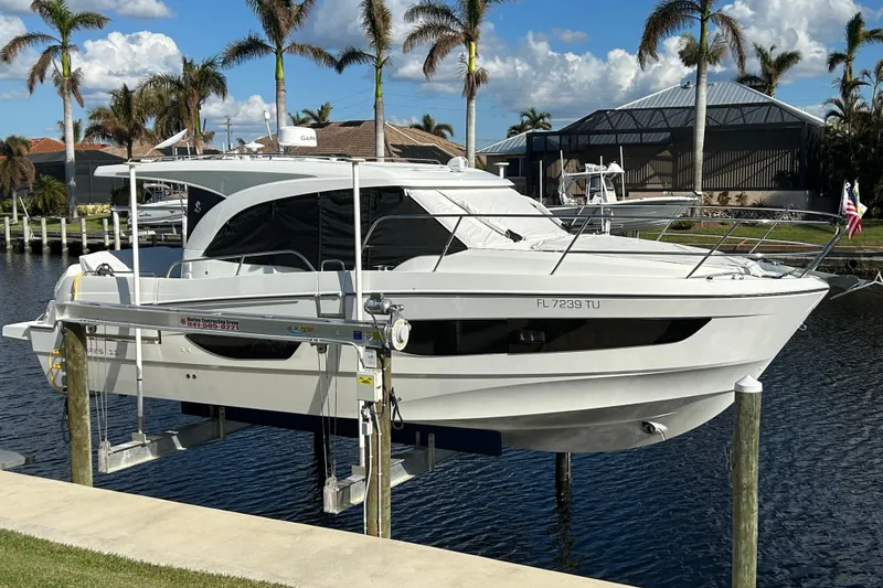 Slide: The Image of 2024 Beneteau Antares 11 yacht docked, surrounded by palm trees and clear skies. - 3