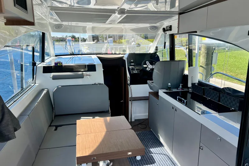 Slide: The Image of Interior of 2024 Beneteau Antares 11, featuring modern helm, seating, and kitchenette. - 7