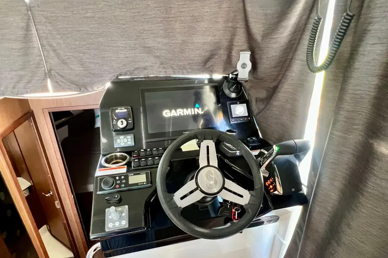 Slide: The Image of 2024 Beneteau Antares 11 helm with Garmin navigation system and modern controls. - 8