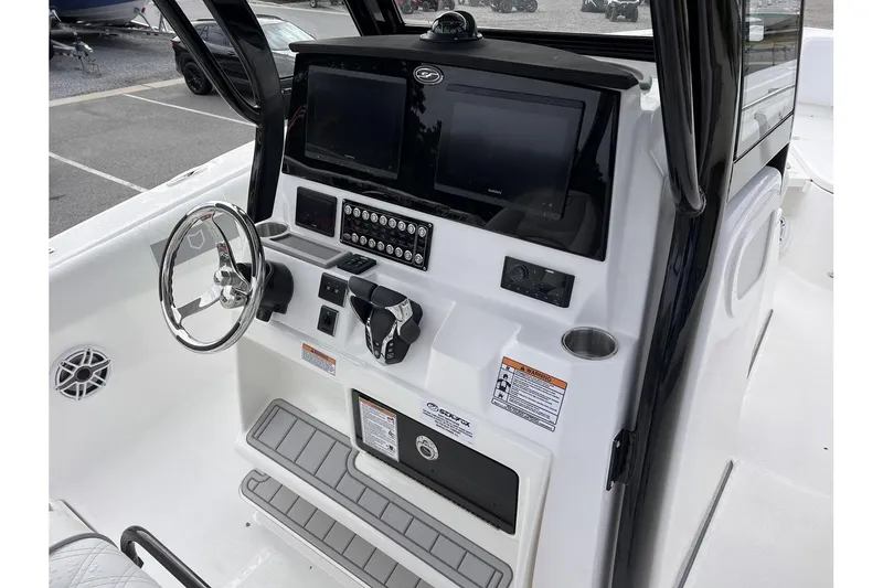 Slide: The Image of 2025 Sea Fox 288 Commander boat dashboard with dual screens and steering wheel. - 12