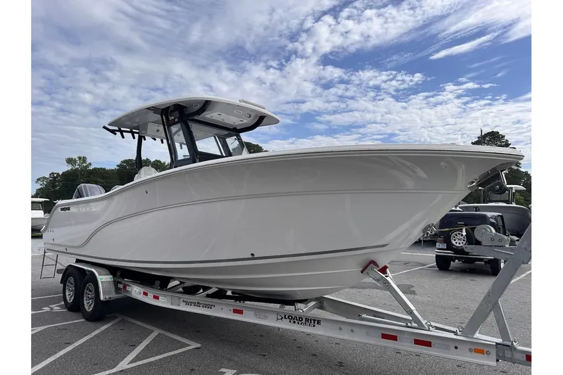 Slide: The Image of 2025 Sea Fox 288 Commander boat on a trailer under a partly cloudy sky. - 6