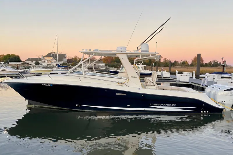 The Image of 2008 Hydra-Sports Vector 3500 VX boat docked at sunset, reflecting on calm water. - 0