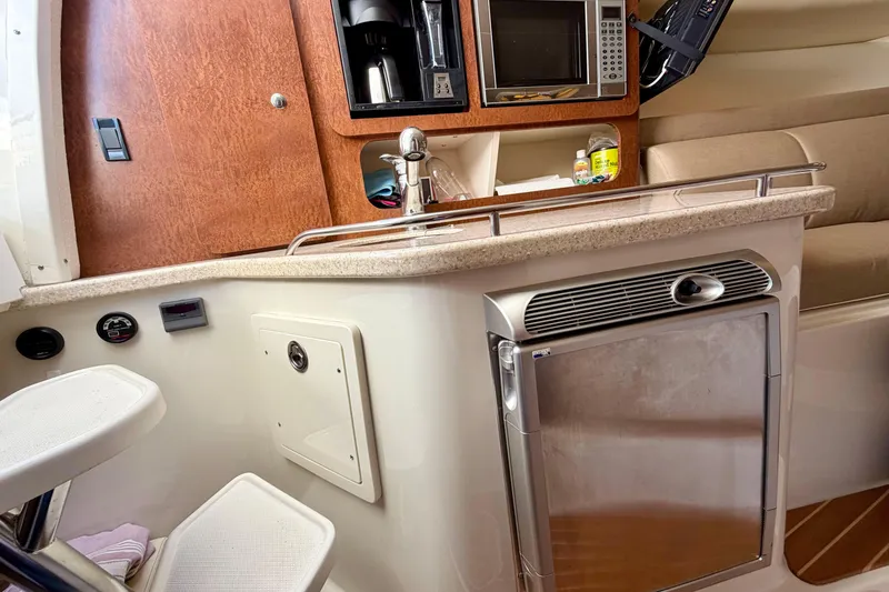 Slide: The Image of 2008 Hydra-Sports Vector 3500 VX cabin with kitchenette, featuring microwave, sink, and fridge. - 26