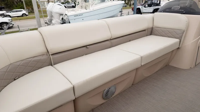 Slide: The Image of 2019 Sun Tracker 24 Party Barge interior seating with beige upholstery and quilted accents. - 14