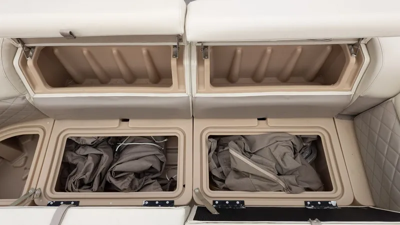 Slide: The Image of Open storage compartments on a 2019 Sun Tracker 24 Party Barge boat, showing interior space. - 15