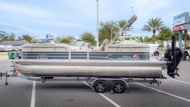 Slide: The Image of 2019 Sun Tracker 24 Party Barge pontoon boat on trailer in parking lot. - 4