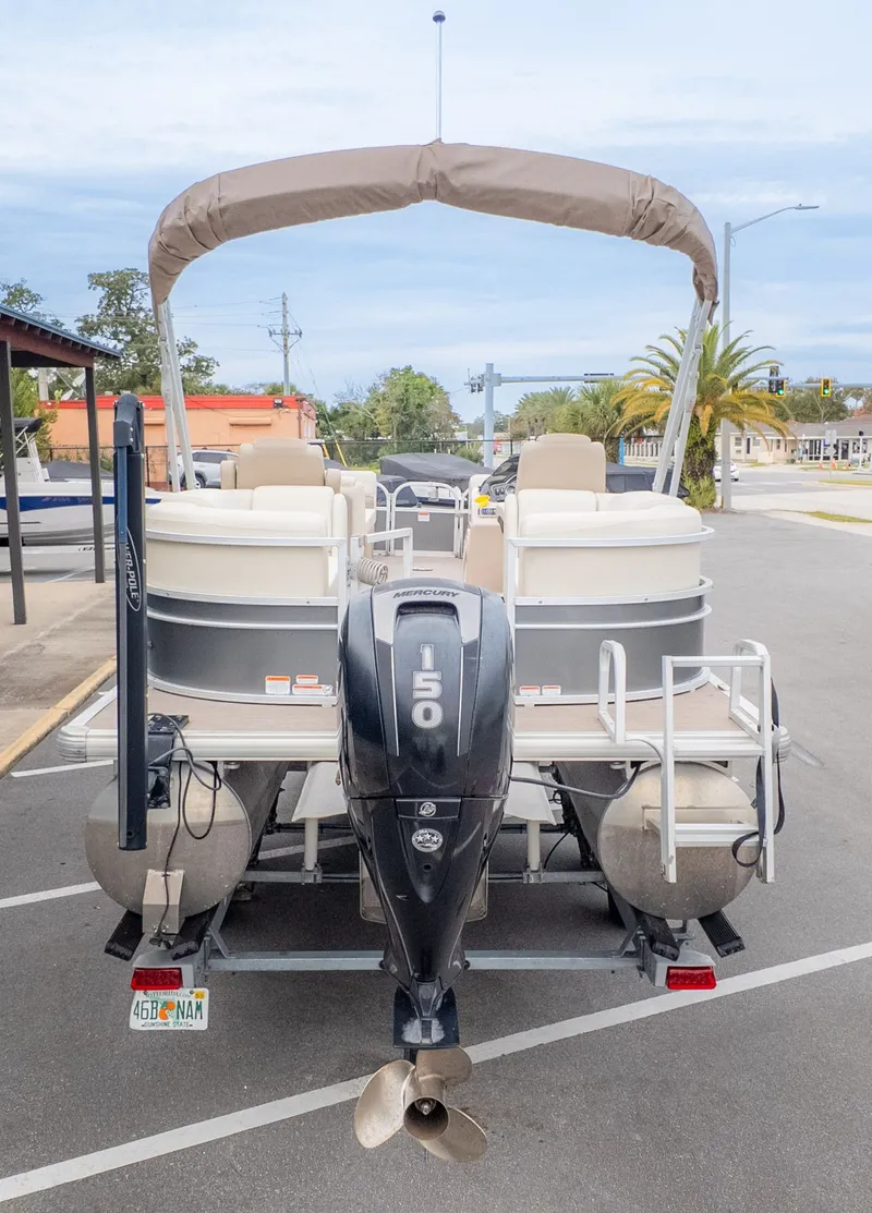 Slide: The Image of 2019 Sun Tracker 24 Party Barge pontoon boat with 150 HP engine, parked in a lot. - 5