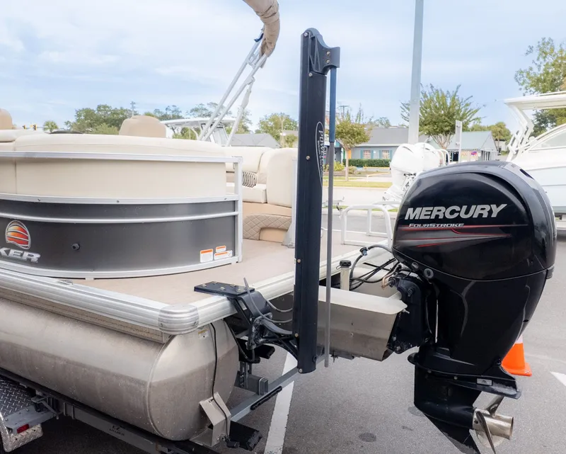 Slide: The Image of 2019 Sun Tracker 24 Party Barge pontoon boat with Mercury FourStroke engine, parked outdoors. - 6
