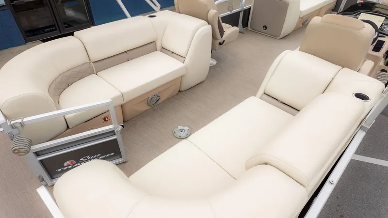 Slide: The Image of 2019 Sun Tracker 24 Party Barge interior with beige seating and spacious layout. - 7