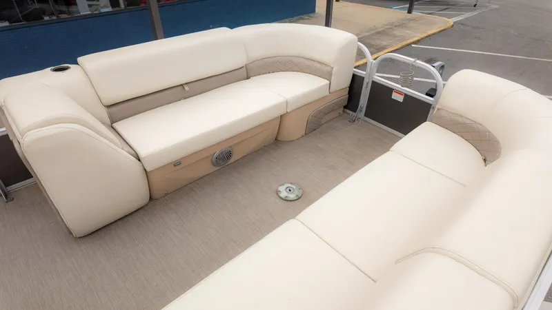 Slide: The Image of 2019 Sun Tracker 24 Party Barge interior with beige seating and spacious layout. - 8