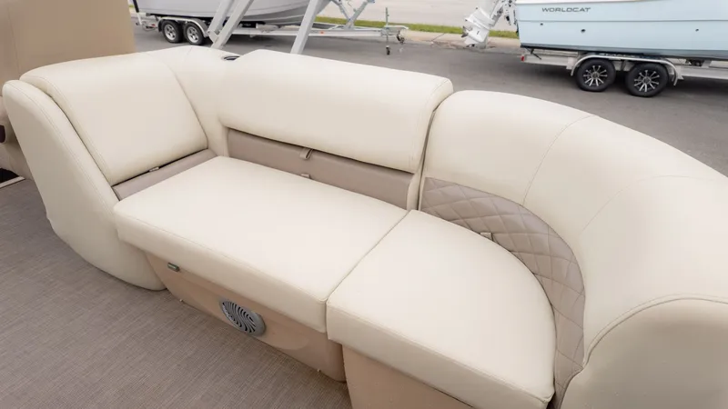 Slide: The Image of Luxurious seating on 2019 Sun Tracker 24 Party Barge, featuring cream upholstery and quilted accents. - 9