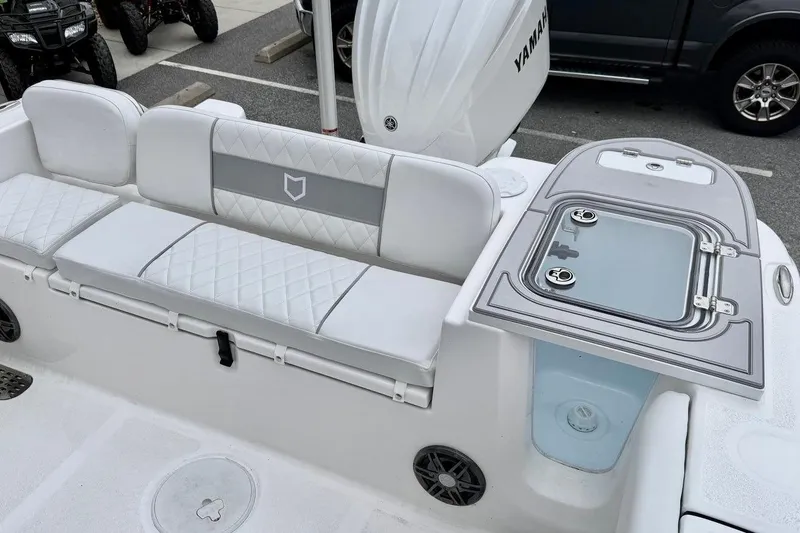 Slide: The Image of 2026 Sea Fox 248 Commander boat interior with white seating and storage compartment. - 10