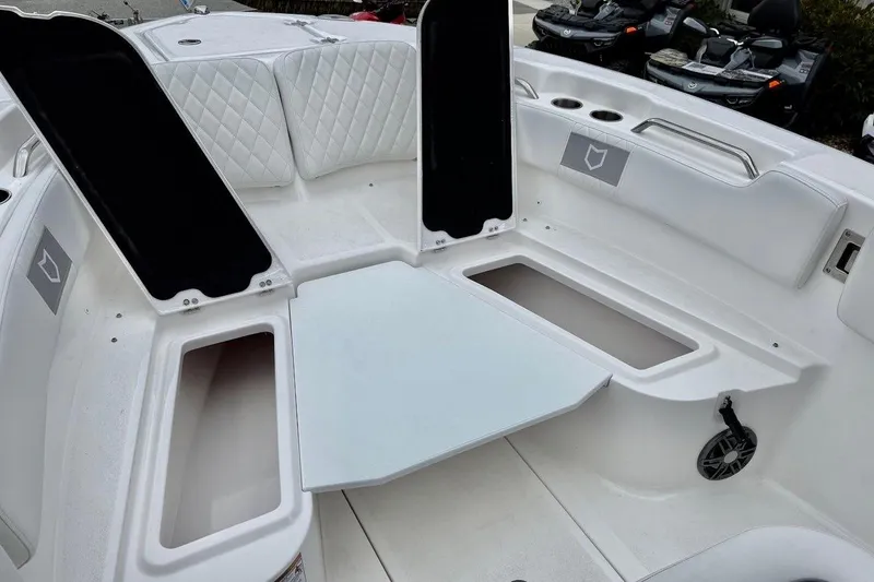 Slide: The Image of 2026 Sea Fox 248 Commander boat interior with open storage compartments and seating. - 4