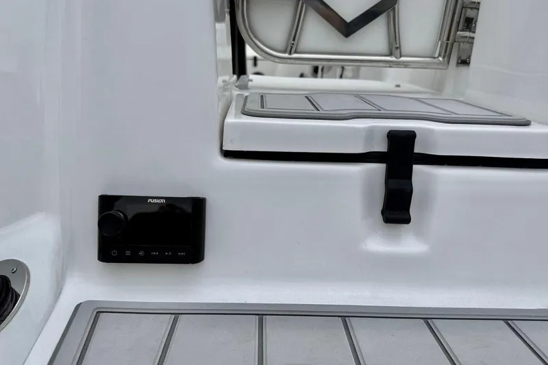 Slide: The Image of 2026 Sea Fox 248 Commander boat interior with Fusion audio system and storage compartment. - 5
