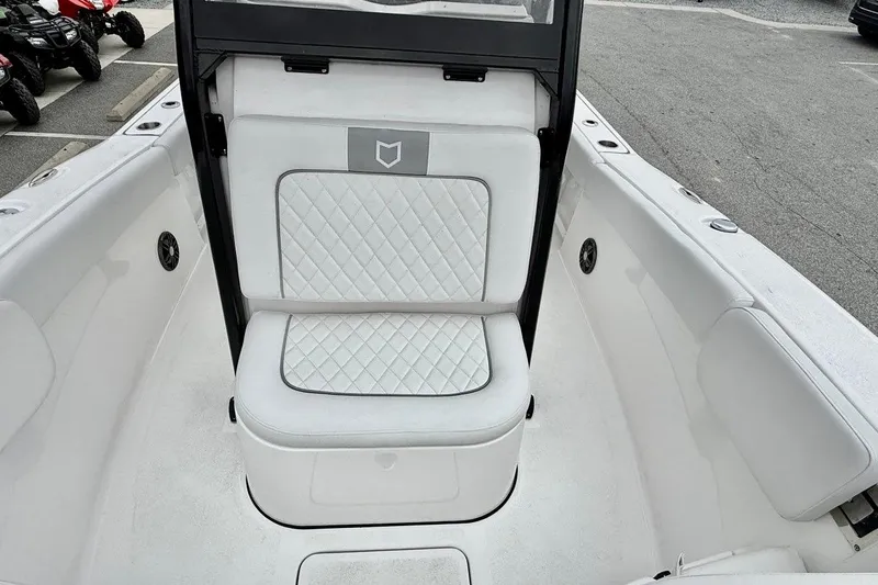 Slide: The Image of 2026 Sea Fox 248 Commander boat interior with white cushioned seating and sleek design. - 6