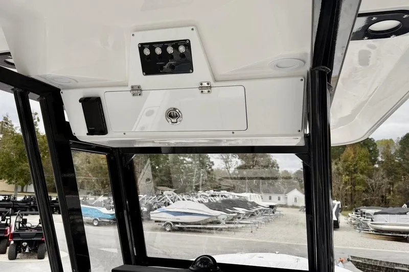 Slide: The Image of 2026 Sea Fox 248 Commander boat console with control panel and storage compartment. - 8