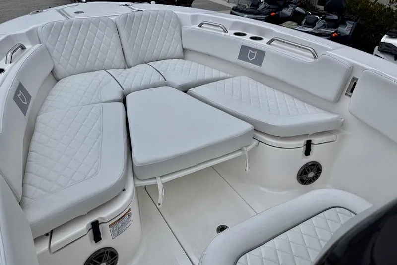 Slide: The Image of 2026 Sea Fox 248 Commander boat interior with white quilted seating and storage compartments. - 9