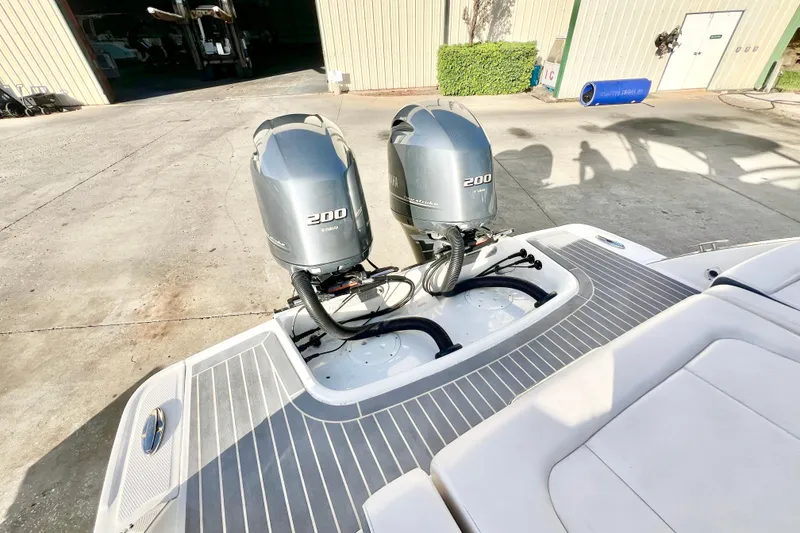 Slide: The Image of 2021 Chaparral 280 OSX boat on display outside a large warehouse. - 10