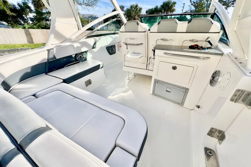 Slide: The Image of 2021 Chaparral 280 OSX boat with dual Yamaha 200 engines, docked outdoors. - 12