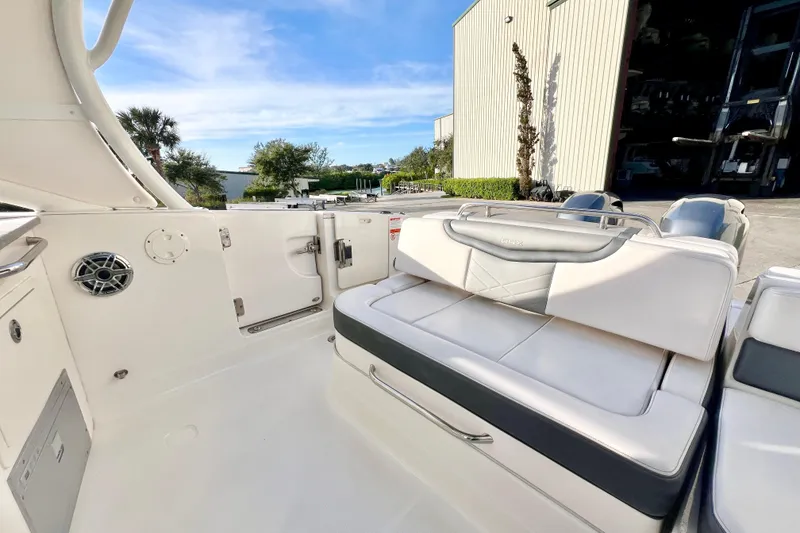 Slide: The Image of 2021 Chaparral 280 OSX boat interior at Indian Springs Marina, featuring seating and helm. - 13