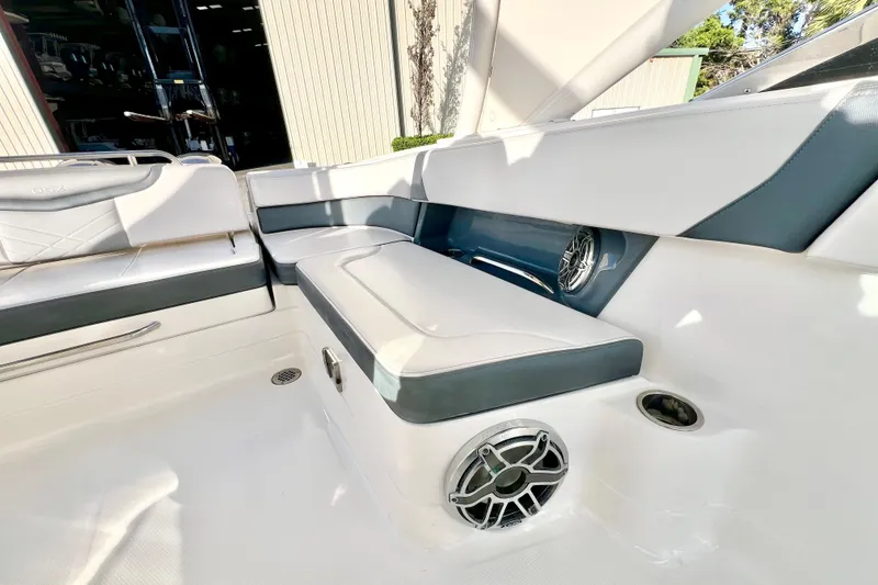 Slide: The Image of 2021 Chaparral 280 OSX boat interior with white seating and modern design. - 16