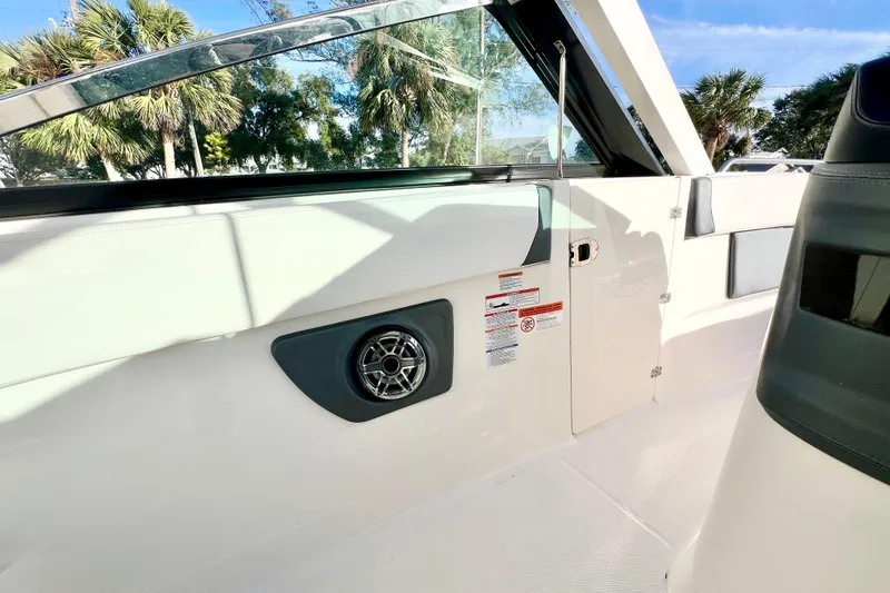 Slide: The Image of 2021 Chaparral 280 OSX boat interior with white and gray seating. - 17