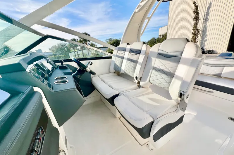 Slide: The Image of 2021 Chaparral 280 OSX boat interior with speaker and seating, featuring sleek design elements. - 19