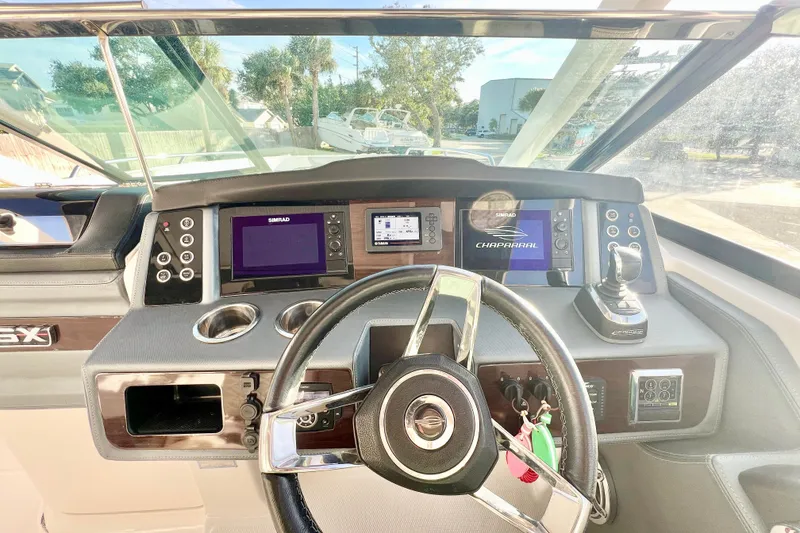 Slide: The Image of 2021 Chaparral 280 OSX boat interior with seating, console, and safety equipment. - 20