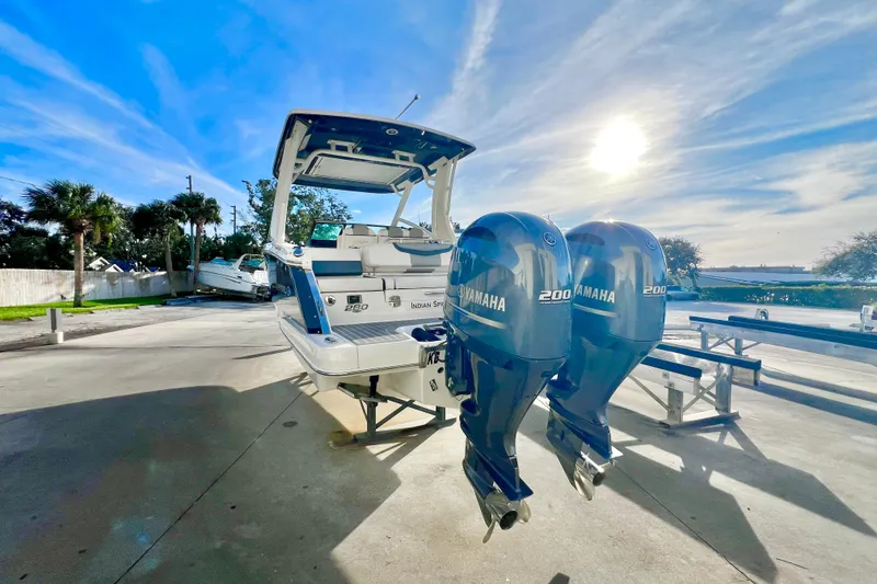 Slide: The Image of 2021 Chaparral 280 OSX boat with dual Yamaha 200 engines, docked outdoors. - 4
