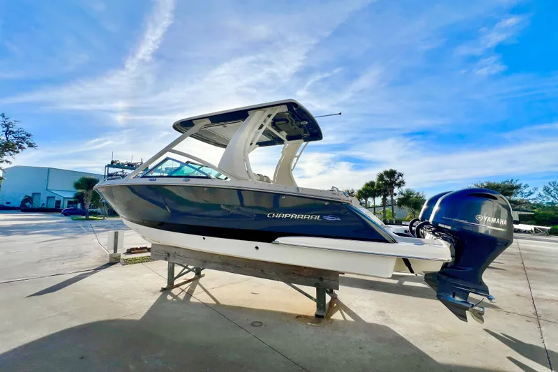 Slide: The Image of 2021 Chaparral 280 OSX boat with twin Yamaha 200 engines under a bright sky. - 6
