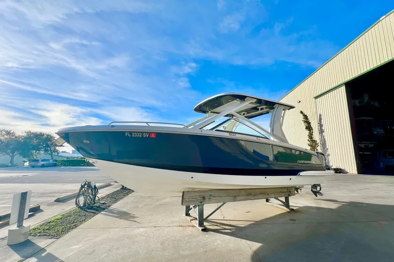 Slide: The Image of Chaparral 280 OSX 2021 boat with Yamaha engine under a bright sky. - 7