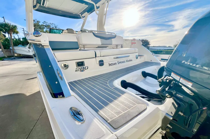 Slide: The Image of 2021 Chaparral 280 OSX boat on display outside a large warehouse. - 9