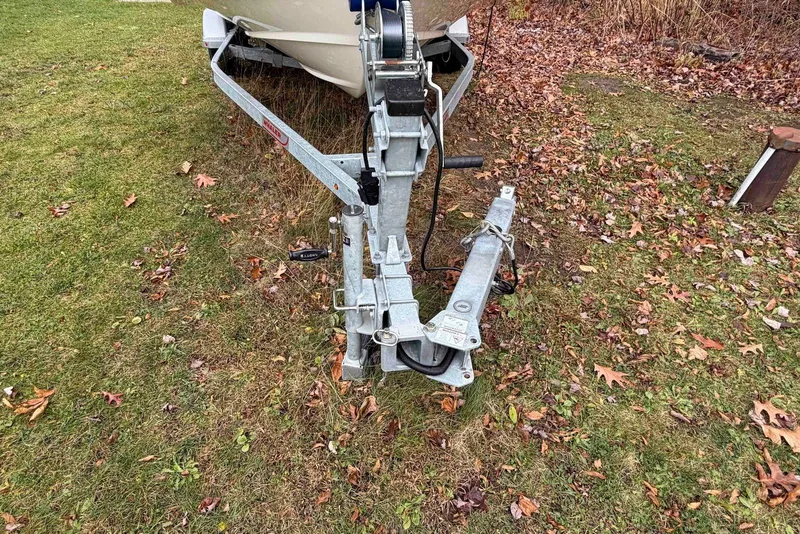 Slide: The Image of Trailer hitch of a 2020 Boston Whaler 190 Montauk on grassy ground with autumn leaves. - 10