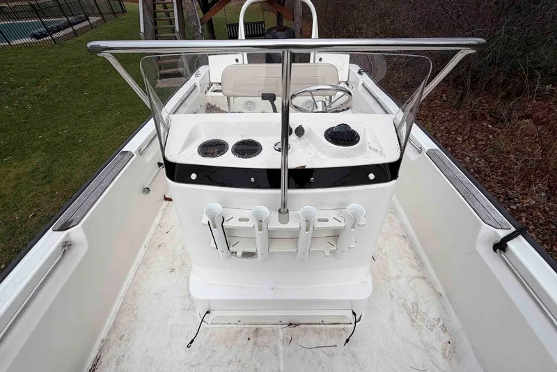 Slide: The Image of 2020 Boston Whaler 190 Montauk boat interior with steering console and rod holders. - 14